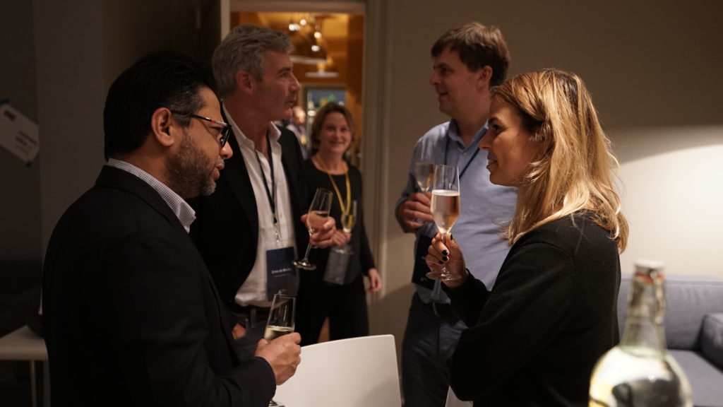 group-talks-in-circle-holding-champagne-flutes